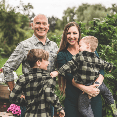 A picture of Emily Kyle and her family in a cannabis garden.