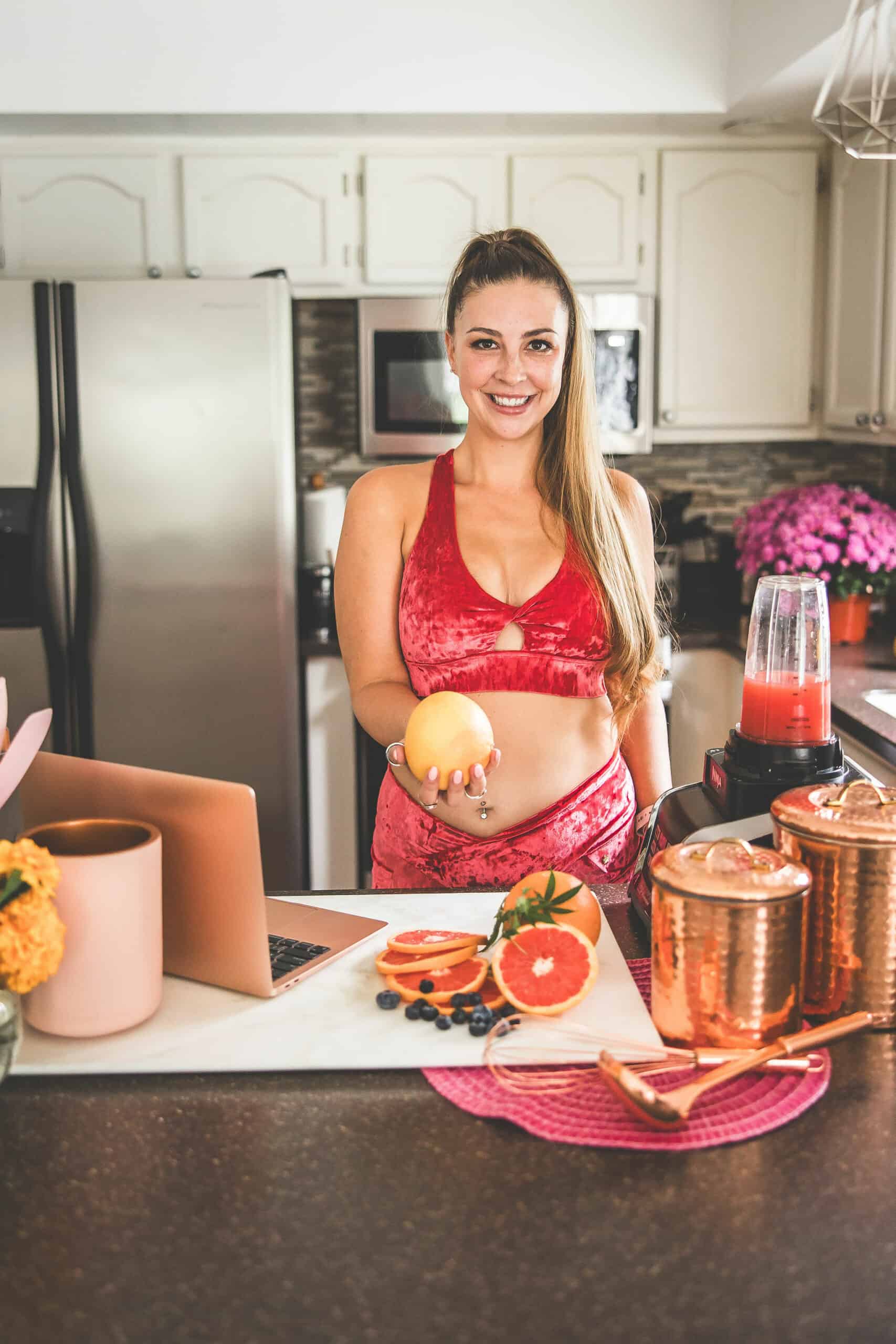 A picture of Emily Kyle holding a grapefruit.