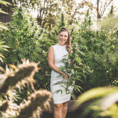 A picture of Emily Kyle in a cannabis garden.