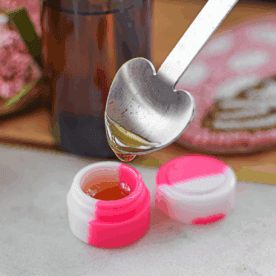 Homemade magic mushroom concentrate dripping from a spoon by Emily Kyle, MS, RDN.