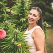 Cannabis plants with Emily Kyle outdoors, promoting medical marijuana, CBD, and cannabis education.