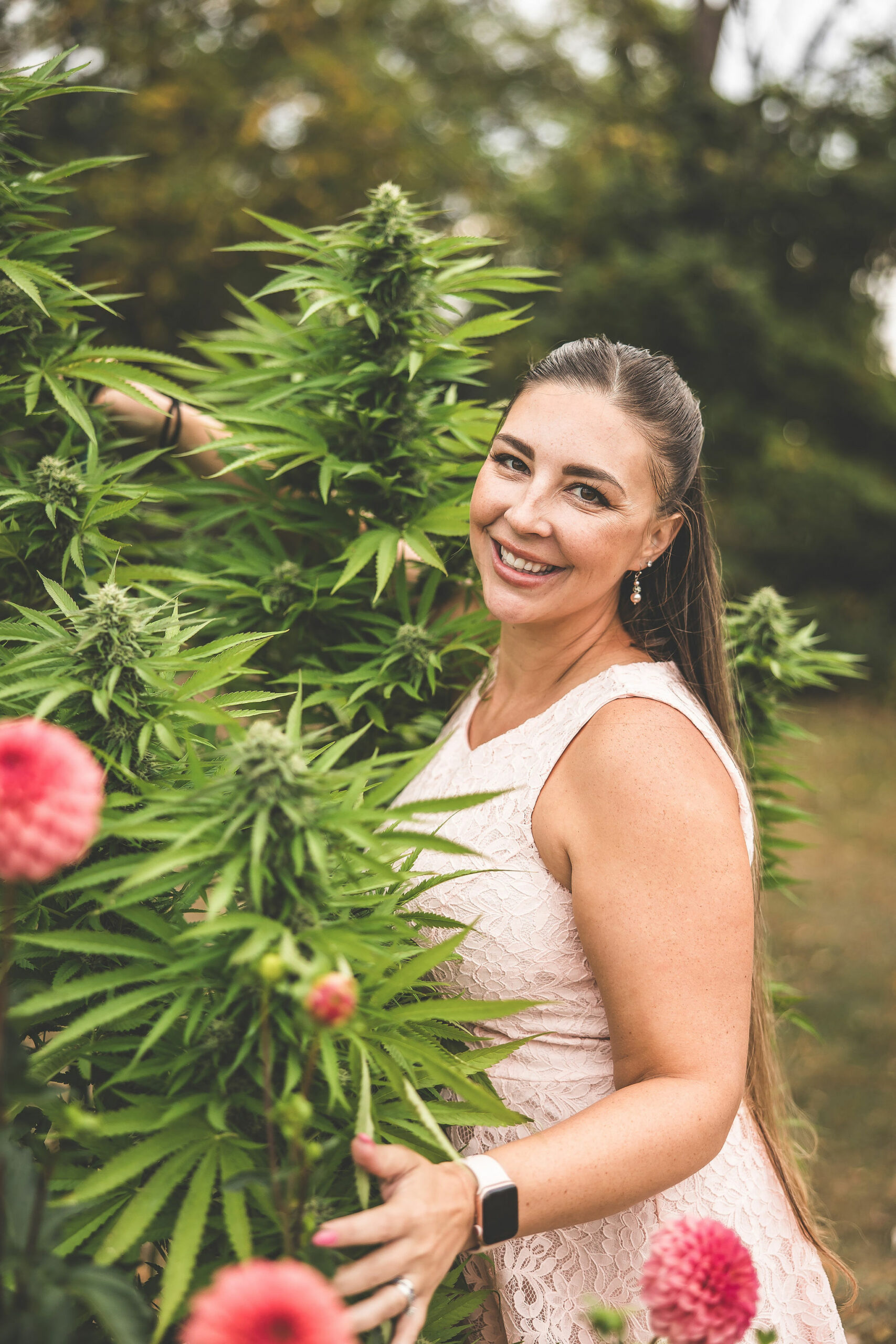 Cannabis plants with Emily Kyle outdoors, promoting medical marijuana, CBD, and cannabis education.