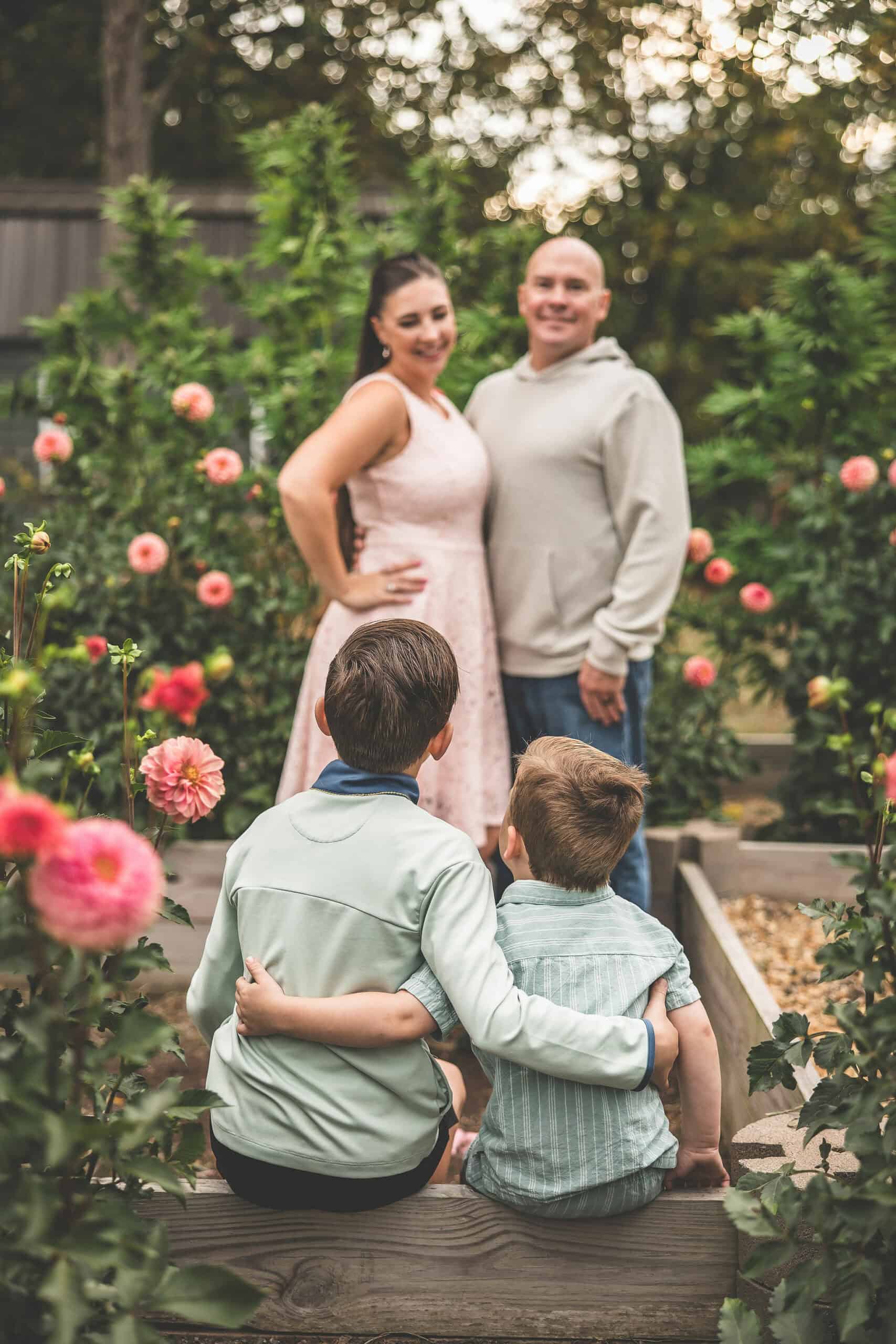 Healthy family enjoying time together in a garden with blooming roses.